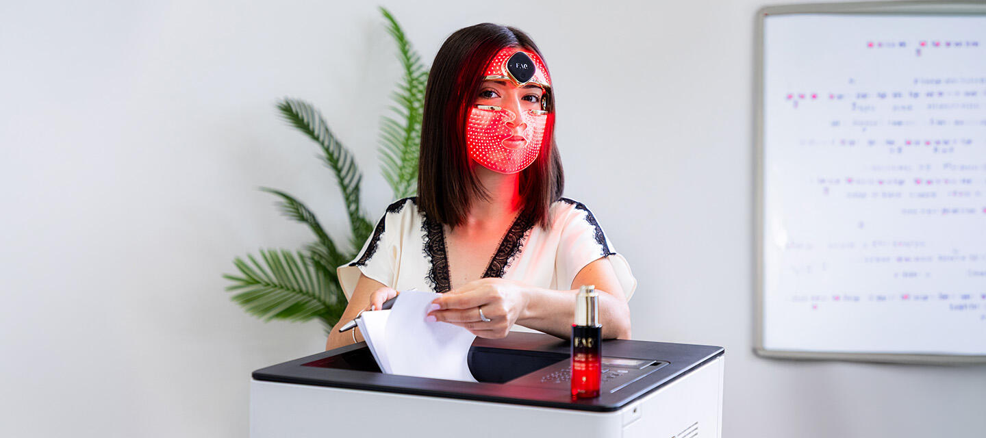 A woman using FAQ 202 mask in the office