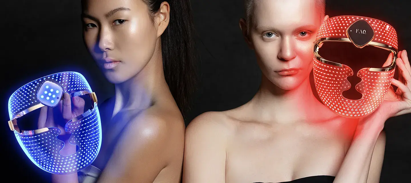 Two women using FAQ 202 plus NIR and red light therapy face masks with blue and red light therapy