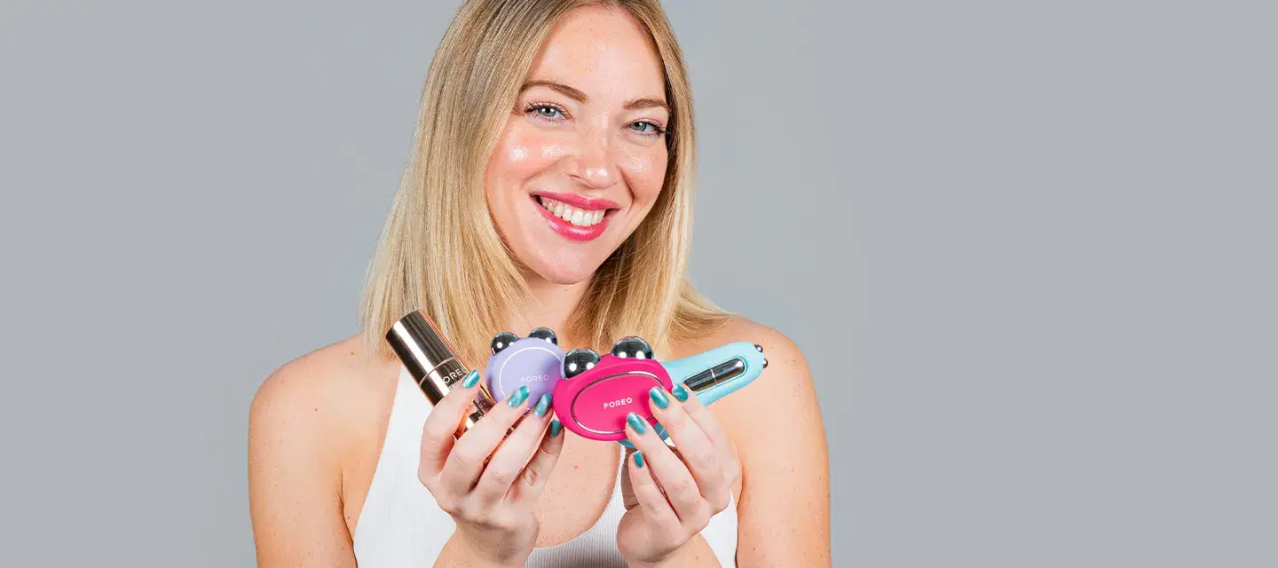 A woman holding multiple microcurrent toning devices on sale
