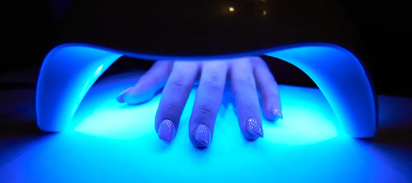 gel manicure curing in a blue light for nails manicure 