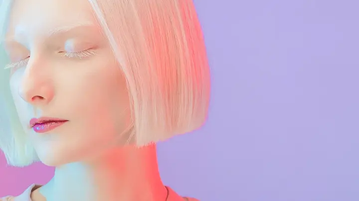 A beautiful albino girl with bob hair style and long lashes under neon light