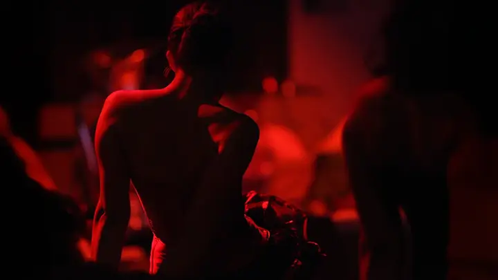 A woman in red light