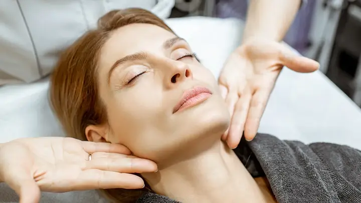 A woman getting a lymphatic drainage massage on face