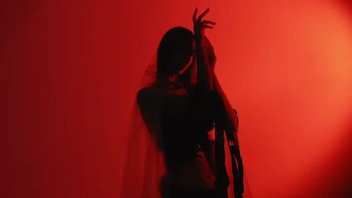 A woman dancing in red lights