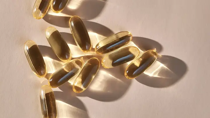 Translucent supplement capsules glistening in the light 