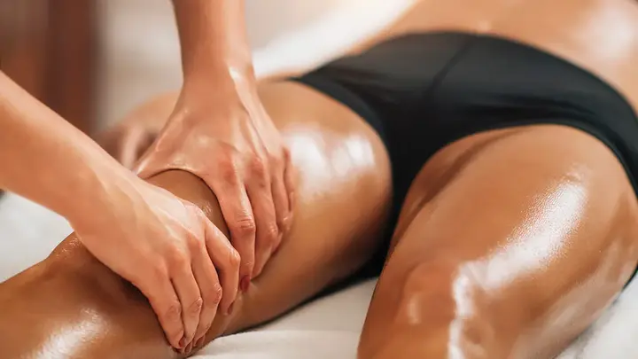A tanned woman in black cotton underwear getting an expert brazilian lymphatic drainage massage