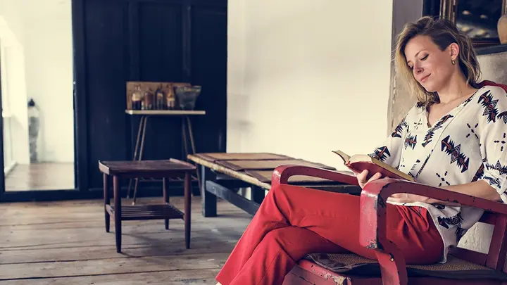 A woman reading a book and enjoying her day