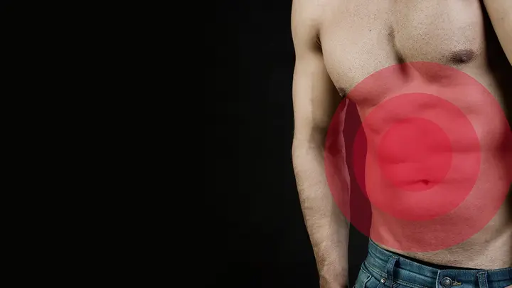 A torso of a muscular man with gut problems