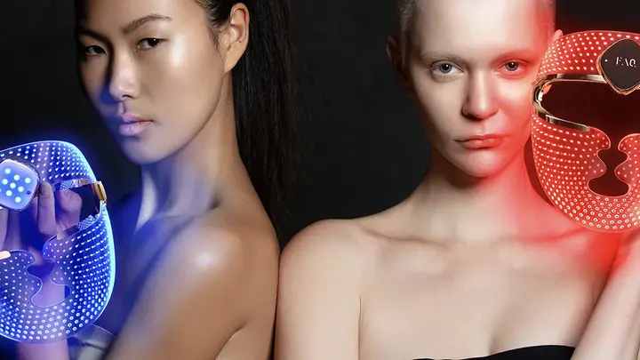 Two women using FAQ 202 plus NIR and red light therapy face masks with blue and red light therapy