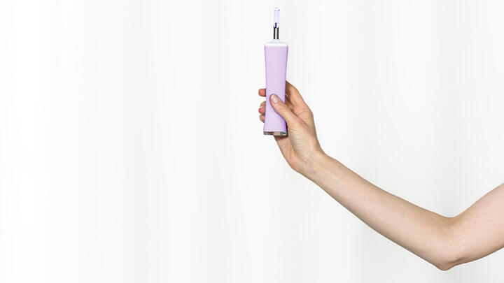 Hand holding FOREO ESPADA acne treatment device