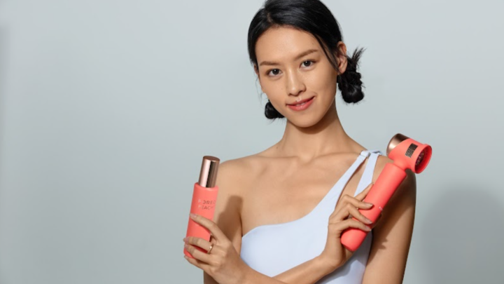 Young female model holding FOREO PEACH 2 IPL device and PEACH Cooling Prep Gel